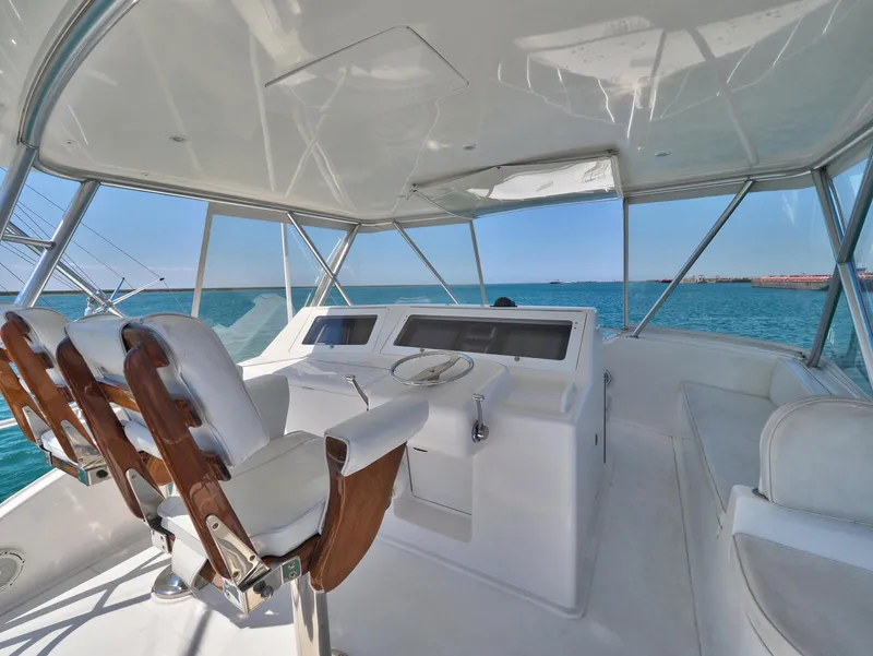 Slide: The Image of 2007 Viking Convertible yacht helm with white seating and ocean view. - 6