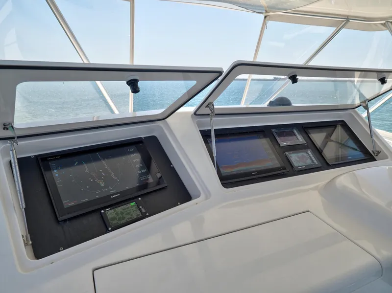 Slide: The Image of 2007 Viking Convertible yacht helm with advanced navigation displays and ocean view. - 8