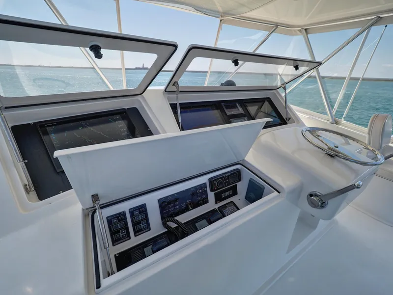 Slide: The Image of 2007 Viking Convertible yacht helm with advanced navigation controls and ocean view. - 9