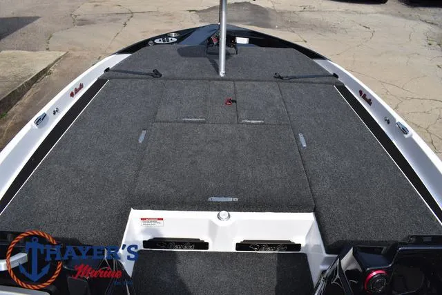 Slide: The Image of 2025 Bass Cat Puma STS boat deck with carpeted surface and storage compartments. - 16