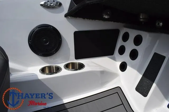 Slide: The Image of 2025 Bass Cat Puma STS boat interior with speaker, cup holders, and Thayer's Marine logo. - 28