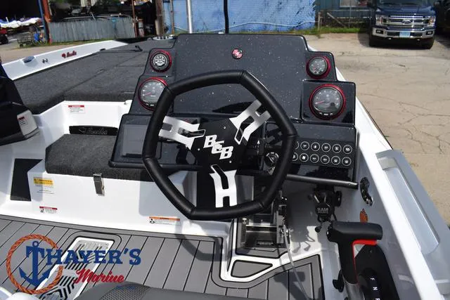 Slide: The Image of 2025 Bass Cat Puma STS boat dashboard with steering wheel and controls. - 36