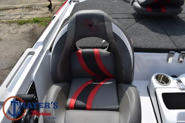 Slide: The Image of 2025 Bass Cat Puma STS boat seat with red and gray design, Thayer's Marine logo. - 42