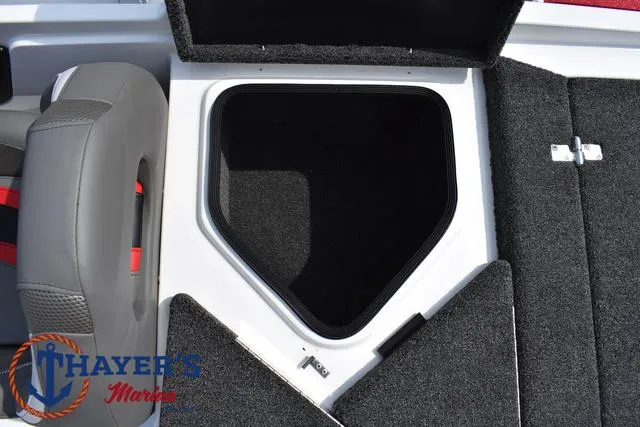 Slide: The Image of 2025 Bass Cat Puma STS boat storage compartment with gray seating and carpeted interior. - 46