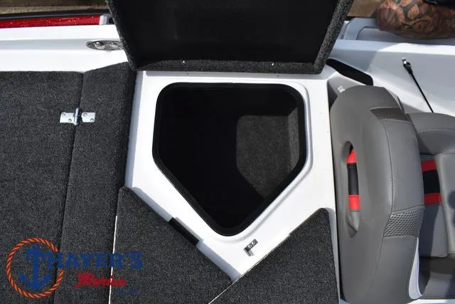 Slide: The Image of 2025 Bass Cat Puma STS boat storage compartment with open lid and seating area. - 47