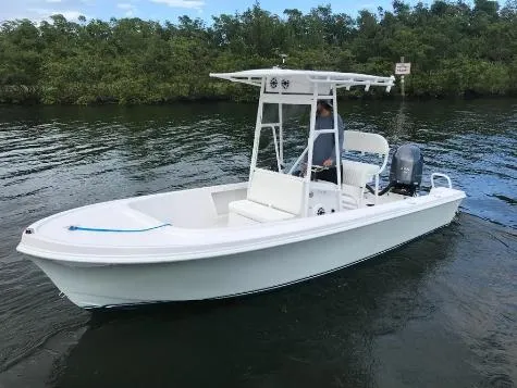 The Image of 1993 Mako 19 boat on water, featuring center console and outboard motor. - 1