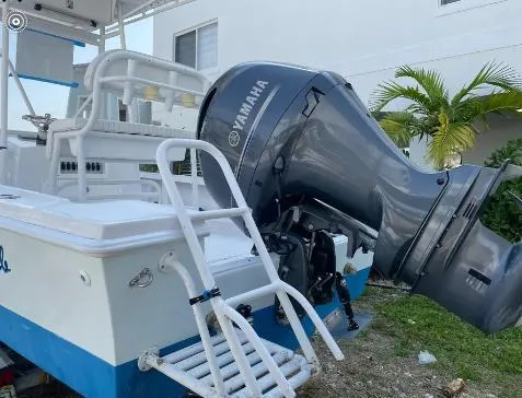 Slide: The Image of 1993 Mako 19 boat with Yamaha outboard motor, parked near a building. - 4