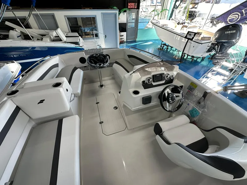 Slide: The Image of 2026 Starcraft SVX 171 OB boat interior with storage compartment and cushioned seating. - 12