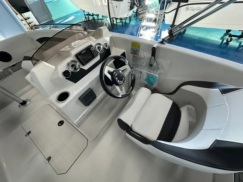 Slide: The Image of 2026 Starcraft SVX 171 OB boat cockpit with steering wheel and modern dashboard. - 13