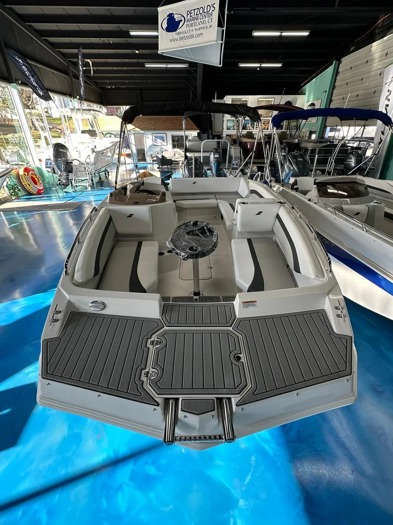 Slide: The Image of 2026 Starcraft SVX 171 OB boat interior with seating, table, and control panel. - 18