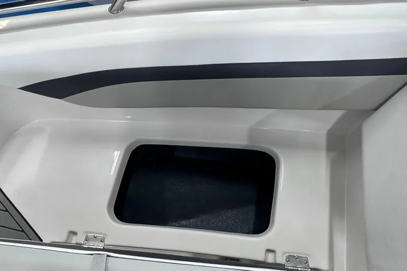 Slide: The Image of 2026 Starcraft SVX 171 OB boat interior storage compartment, featuring sleek white and gray design. - 23