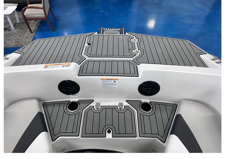 Slide: The Image of 2026 Starcraft SVX 171 OB boat deck with gray non-slip surface and cup holders. - 24