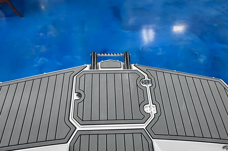 Slide: The Image of 2026 Starcraft SVX 171 OB boat deck with gray non-slip surface and blue background. - 26