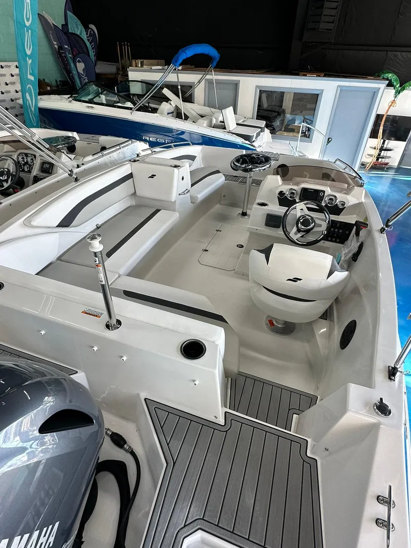 Slide: The Image of 2026 Starcraft SVX 171 OB boat interior with seating and steering console. - 9