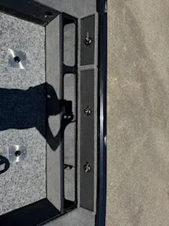 Slide: The Image of 2024 Ranger VS1665SC boat interior with storage compartments and carpeted flooring. - 12