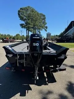 Slide: The Image of 2024 Ranger VS1665SC boat with 50HP motor, parked outdoors. - 6