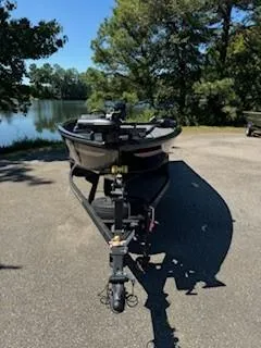Slide: The Image of 2024 Ranger VS1665SC boat on trailer, parked near a scenic lake. - 8