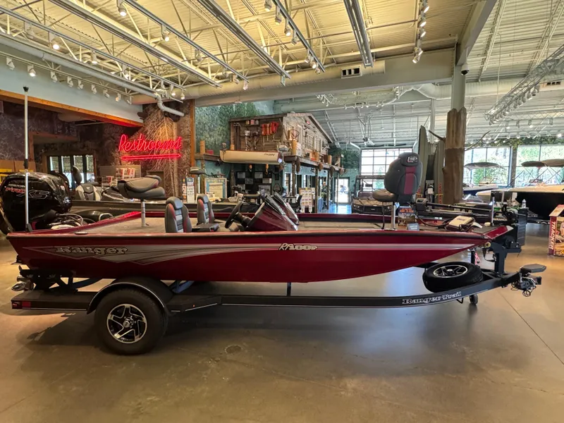 Slide: The Image of 2024 Ranger RT188P boat displayed in a showroom, featuring a sleek red design. - 0