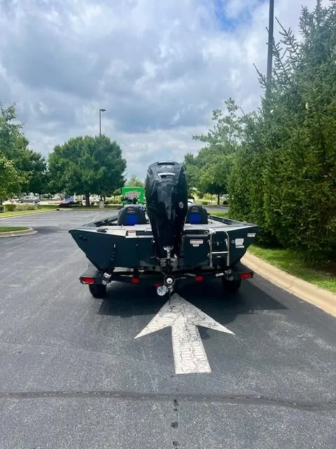 Slide: The Image of 2024 Ranger RT178 boat on trailer in parking lot, surrounded by trees. - 5