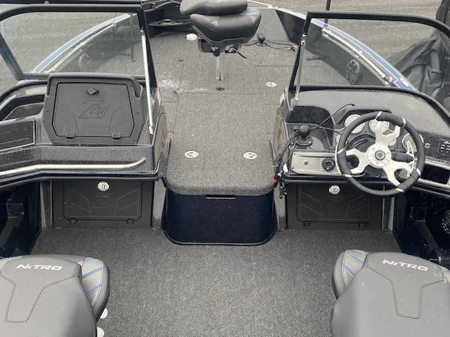 Slide: The Image of 2024 Nitro ZV20 Pro boat interior with steering wheel and seating. - 2