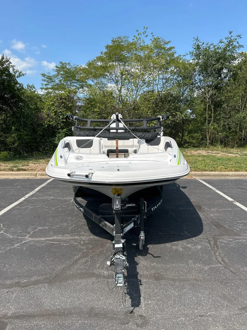 Slide: The Image of 2024 Tahoe 1950 boat on trailer in parking lot, surrounded by trees. - 3