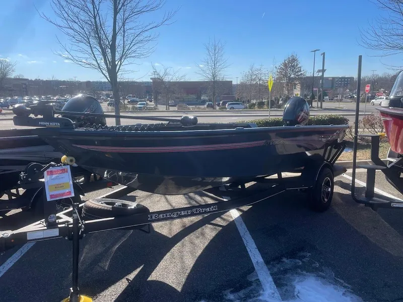 The Image of 2024 Ranger VS1665T boat on trailer in parking lot, sunny day. - 0