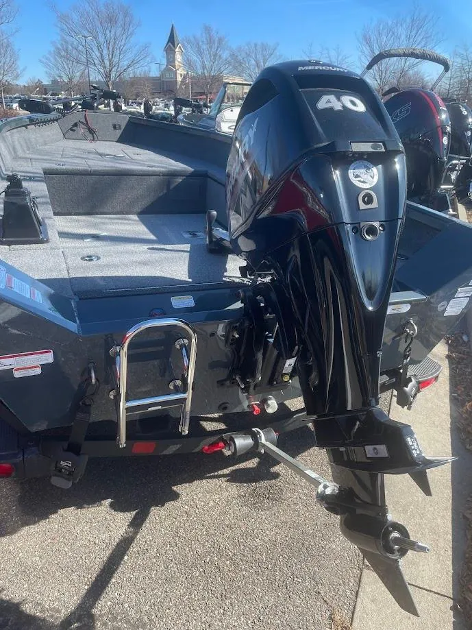 Slide: The Image of 2024 Ranger VS1665T boat with 40 HP outboard motor, parked outdoors. - 3