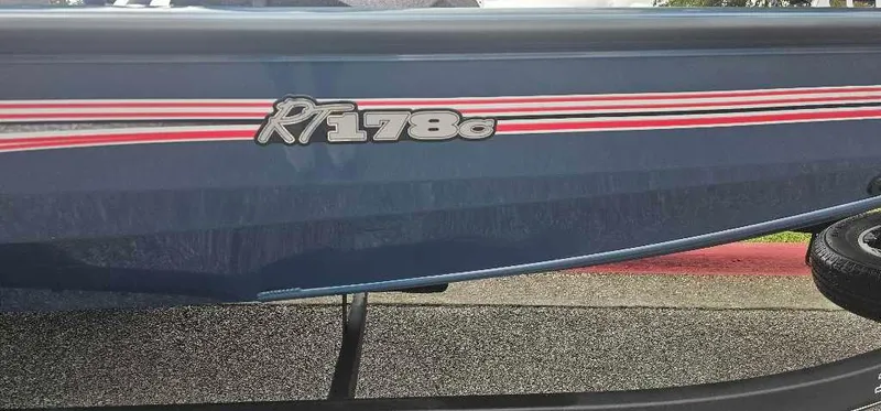 Slide: The Image of 2024 Ranger RT178C boat with blue and red detailing. - 2
