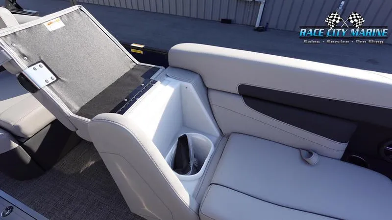 Slide: The Image of 2025 Barletta Cabrio 22U boat interior with open storage compartment and cup holder. - 37