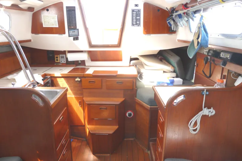 Slide: The Image of Interior of a 1981 Sabre 34 sailboat with wooden cabinetry and seating area. - 17