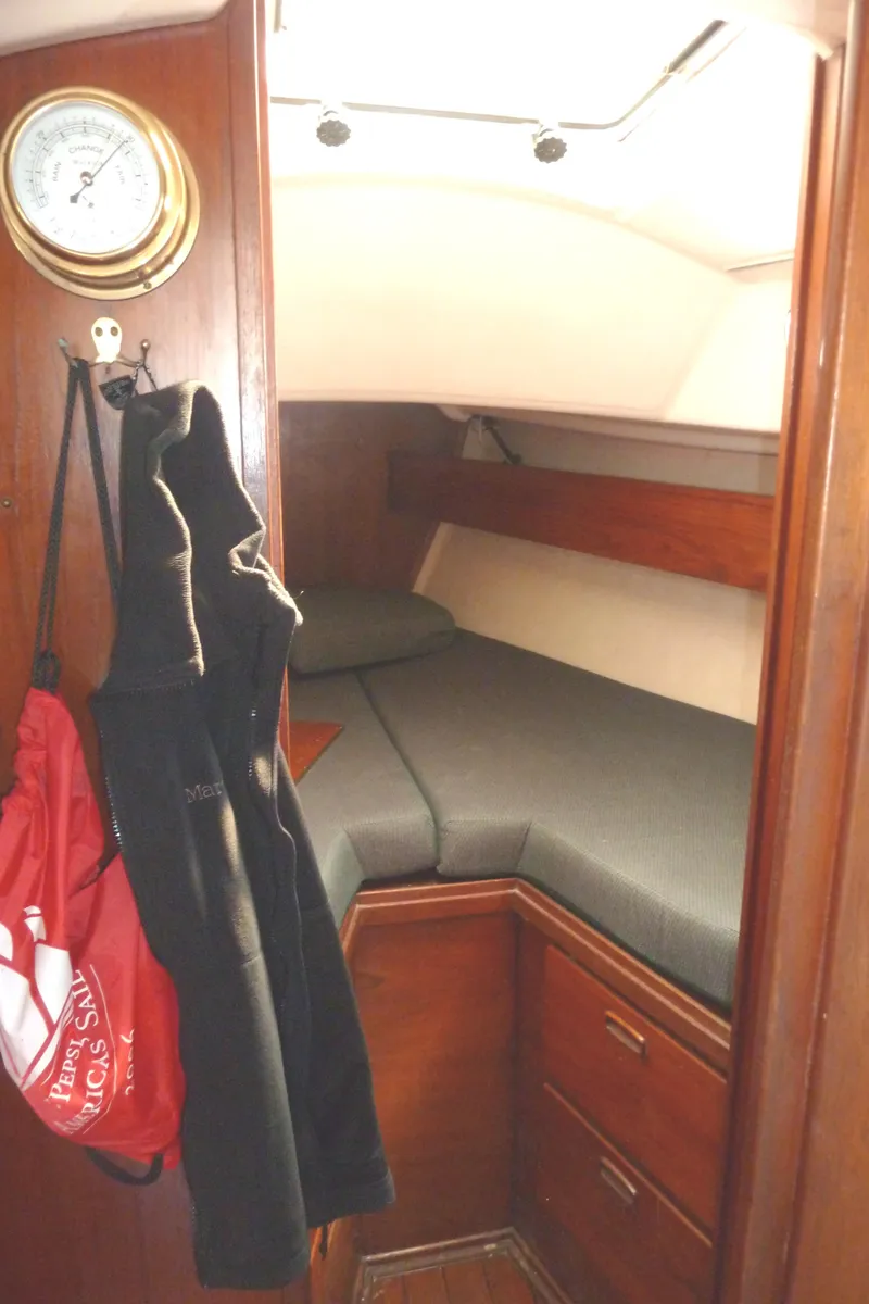 Slide: The Image of 1981 Sabre 34 sailboat cabin with cozy sleeping area and wooden storage. - 20