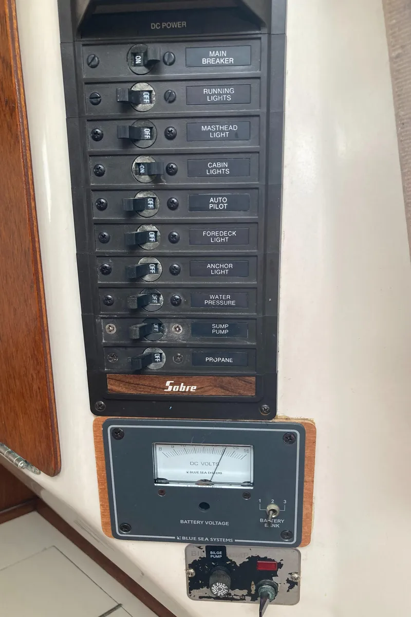Slide: The Image of Electrical panel of a 1981 Sabre 34 sailboat with various switches and a voltage meter. - 23