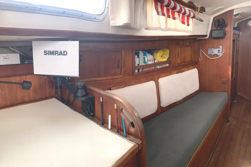 Slide: The Image of Interior of 1981 Sabre 34 sailboat with Simrad navigation system and cozy seating area. - 24