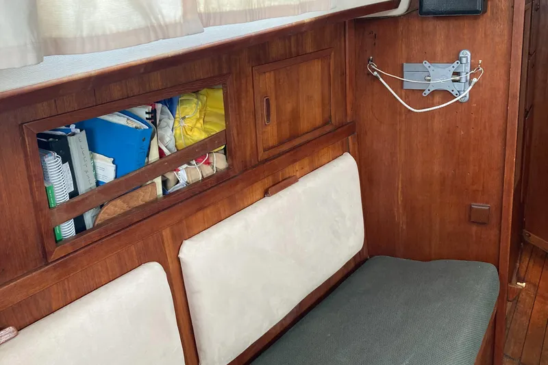 Slide: The Image of Interior of 1981 Sabre 34 sailboat with wooden paneling and cushioned seating. - 25