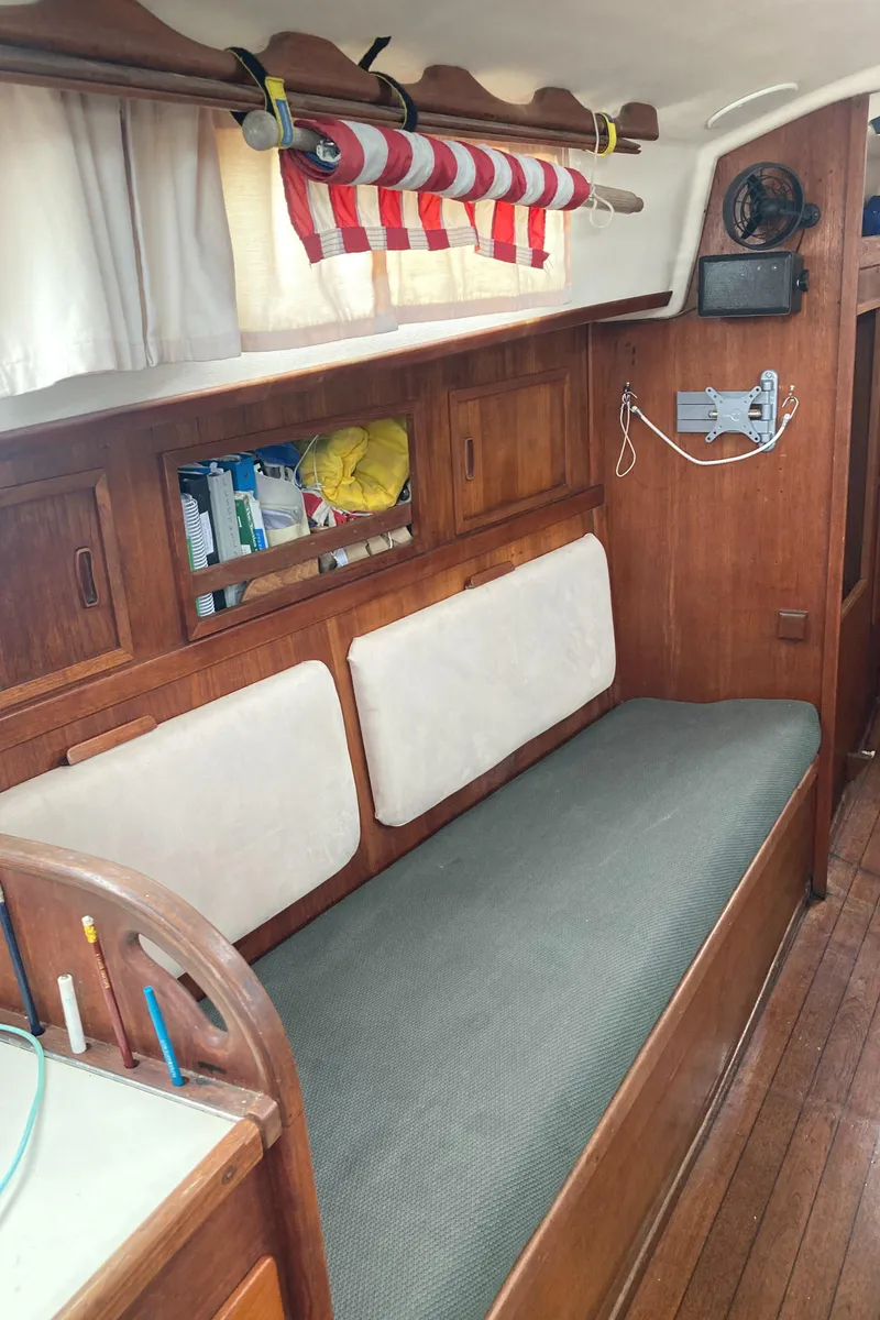 Slide: The Image of Interior of 1981 Sabre 34 sailboat with wooden furnishings and cozy seating area. - 27