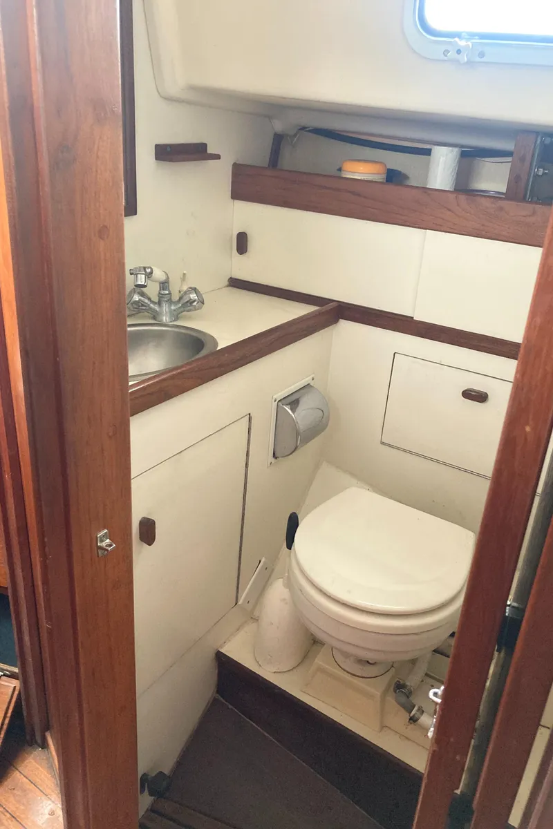 Slide: The Image of 1981 Sabre 34 sailboat bathroom with sink, toilet, and wooden accents. - 30