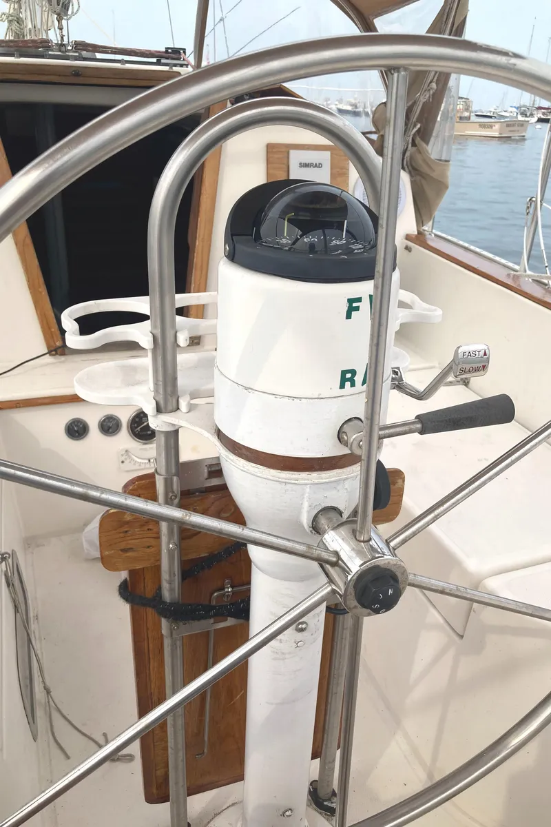 Slide: The Image of 1981 Sabre 34 sailboat helm with compass and stainless steel wheel. - 8