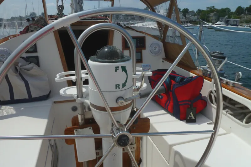 Slide: The Image of 1981 Sabre 34 sailboat cockpit with steering wheel and navigation equipment. - 9