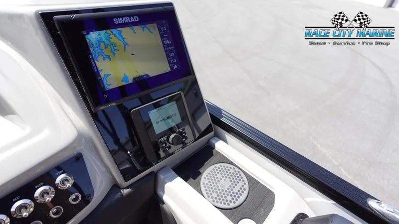 Slide: The Image of Barletta C24QC 2025 boat dashboard with Simrad navigation system, Race City Marine logo. - 16