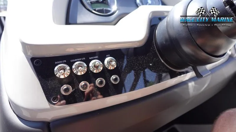 Slide: The Image of Control panel of 2025 Barletta C24QC boat with labeled switches and Race City Marine logo. - 17