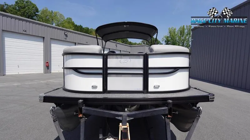Slide: The Image of 2025 Barletta C24QC pontoon boat at Race City Marine dealership. - 2