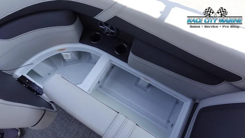 Slide: The Image of 2025 Barletta C24QC boat interior with storage compartment and cup holders. - 25