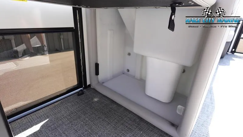 Slide: The Image of 2025 Barletta C24QC boat interior storage compartment with carpeted flooring. - 29