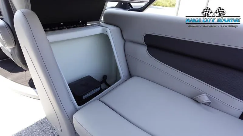 Slide: The Image of 2025 Barletta C24QC boat interior with open storage compartment and gray seating. - 34