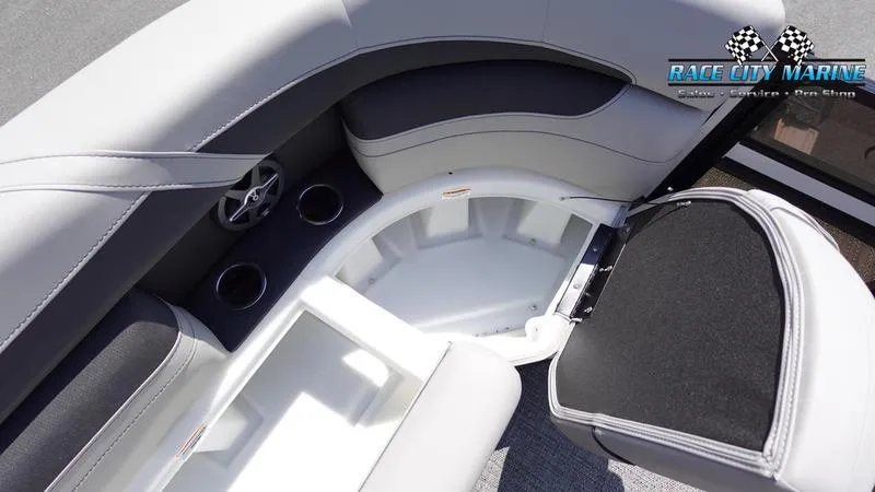 Slide: The Image of 2025 Barletta C24QC boat interior with storage compartment and cup holders. - 36