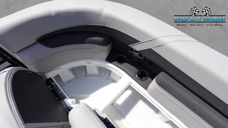 Slide: The Image of Barletta C24QC 2025 boat interior with seating and cup holders, Race City Marine logo. - 39