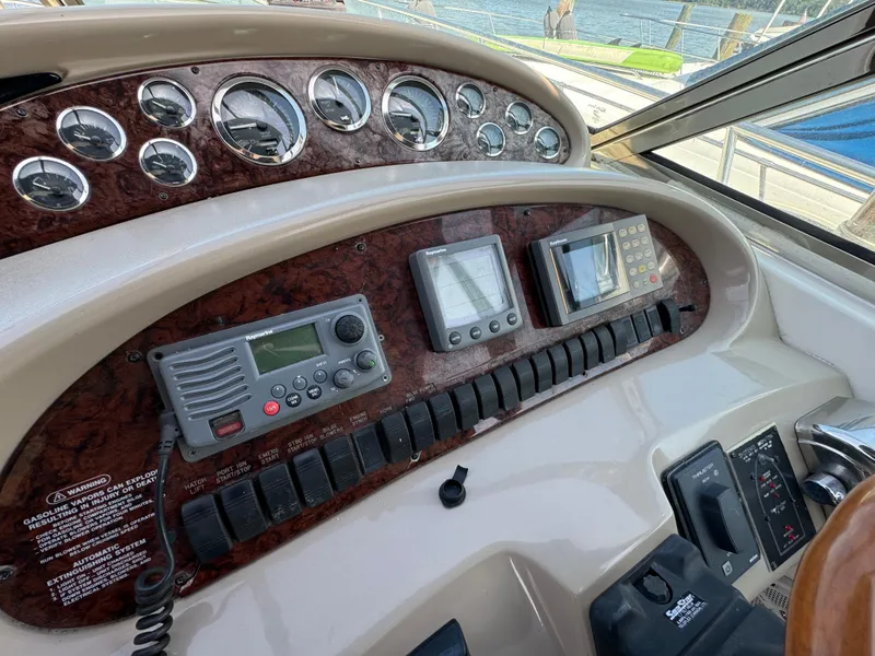 Slide: The Image of 1999 Sea Ray 380 Sundancer dashboard with gauges and navigation equipment. - 15