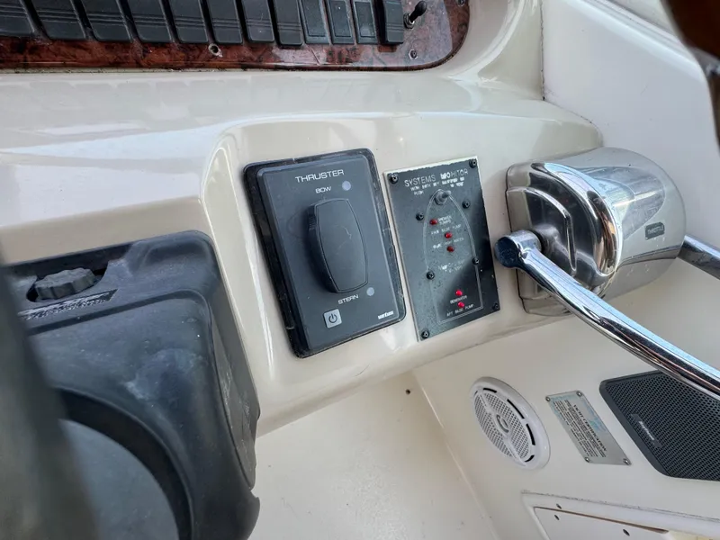 Slide: The Image of 1999 Sea Ray 380 Sundancer helm controls with navigation and throttle systems. - 16