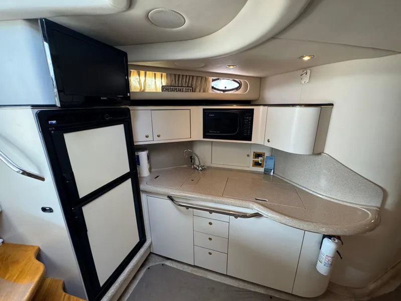 Slide: The Image of Interior of 1999 Sea Ray 380 Sundancer yacht kitchen with modern amenities. - 18