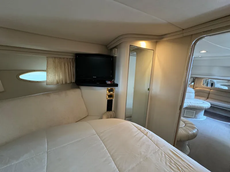 Slide: The Image of Interior of 1999 Sea Ray 380 Sundancer yacht, featuring cozy bedroom and modern amenities. - 23